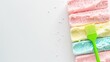 © matoya - Colorful Ice Cream Bars with Green Spatula on White Background