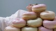 © AI Petr Images - Certainly! Here you go:Tower of pastel donuts beckons atop dreaming Eurasian man, nodding to Donut Day whimsy and serenity indulgence