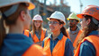 © Viktor - Diverse young students wear safety helmets, bright orange safety vests. Attend field trip, learn on large construction site. Group actively discusses engineering project, industrial work, job