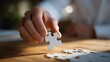 © forenna - Hand carefully placing a puzzle piece into a nearly completed picture on a wooden table — concept of problem-solving, focus, mindfulness, cognitive engagement, and creative leisure activity