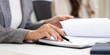 © Fahng - close up hands of Business partners working with analysis report and advisor showing plan, Two businesswoman working with Financial analysts reports and planning investment at office.