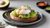 delicious poached egg on avocado toast garnished with microgreens and spices for a healthy breakfast