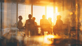 group of professionals engages in a meeting around a table in a glass-walled office, warmly lit by the setting sun, symbolizing collaboration and vision