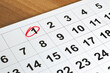 © Careto - Number 1 marked in the calendar with red color circle to point important date on the wooden table