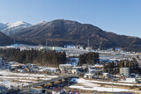 Cityscape of Yudanaka in Japan with snowy mountains in the background. Famous for his snow monkeys bathing in hot spings