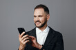 © SHOTPRIME STUDIO - A professional man in a blazer engages with a smartphone, exuding confidence and focus against an isolated colored background, suggesting modern business and clear intent.