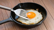 © Made - Frying pan with spatula and sunny side up egg