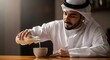 © Ahmad1993 - A man dressed in traditional Middle Eastern attire is pouring a beverage into a bowl at a wooden table in a cozy indoor setting
