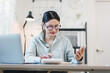 © PRIME STOCK LAB - Focused young asian woman calculating finance and budget in home office, working with laptop and financial bills for her small business