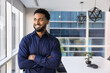© fizkes - Smiling Black man entrepreneur look at window in office boardroom