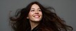 © ckybe - Joyful woman with long flowing hair spread out in dynamic motion