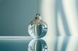 © Yurii - A luxurious clear glass holiday ornament with a gold cap encrusted with diamonds hangs from a chain, reflecting off the shiny surface.
