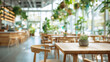 © izzyU - 観葉植物に囲まれた明るいカフェ空間のぼかしイメージ