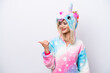 © luismolinero - Young Russian woman with unicorn pajamas isolated on white background pointing to the side to present a product