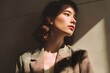 © Studicon - Portrait of a woman in a suit bathed in golden sunlight looking towards the light