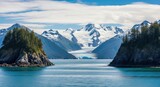 Spectacular Alaskan fjord with a massive tidewater glacier. Snow covered mountain range and pristine blue water. Ecotourism and adventure travel destination. Climate change and melting ice concept