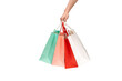 © Somphop - A person's hand holding a paper shopping bag with handles on a clean white background. Studio shot with ample copy space for text, logos, or branding. Isolated on white, cut out.