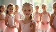 © Vadym - Young girls in pink ballet outfits smile in a dance studio. Children practice a ballet class together indoors. They wear leotards and skirts for their training.