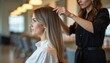 © Vadym - Woman receives haircut in modern salon. Stylist adjusts client hair, focusing on style and color. Pro beauty service for hair transformation.