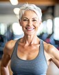 © All - Smiling older woman with short white hair at gym, in tank top