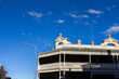 © Austockphoto - flock of cockatoo birds flying over rooftops of Armidale a regional city in Australia