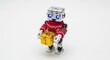 © Svetlana Kulakova - Small robot in Christmas sweater holding tiny gift box with golden wrapping on white background
