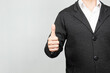 © Alejandro Bernal - a modern businessman at the right of the screen with the right thumb up in approbation gesture with white background