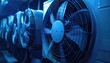 © Muhammad - Row of large industrial fans, close-up, illuminated with a cold blue light, showing depth of field