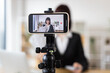 © sofiko14 - Caucasian woman recording financial literacy video showcasing cash, providing investment tips, income insights