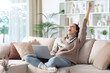 © Antonioguillem - Excited woman celebrating success with a laptop in winter