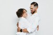 © SHOTPRIME STUDIO - A professional male business figure shares a warm moment with a colleague against an isolated colored background, showcasing confidence, emotion and teamwork in a studio setting.