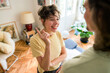 © Westend61 - Smiling young woman standing and discussing with boyfriend at home