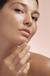 © Buyanskyy Production - Close-Up Of Woman Pointing At Chin Pimple In Realistic Skincare Concept