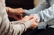 © Kalawin - group of people praying together while holding hand on holy bible book at church. Concept of hope, religion, faith, christianity and god blessing.