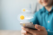 © Thapana_Studio - Satisfaction customer giving positive feedback on mobile phone with five-star rating and smiling emoji. Concept of user experience, and online review system, excellent products and service.