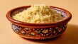 © fivan - A couscous bowl with cream ceramic tones, isolated on beige surface