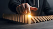 © Ahmed - Strategic hand initiates chain reaction with falling dominoes, symbolizing cause and effect, decision making, and the power of a single action to create momentum for impactful change.