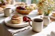 © Галя Дорожинська - Family enjoying breakfast together with pancakes and fresh fruit