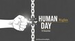 © Taky - International human rights day with hand breaking chain on dark background