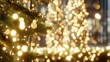 © tao - Close - up of a Christmas tree with pine branches and light bulbs creating a bokeh effect against a blurred background, symbolizing the warm and cozy Christmas atmosphere.