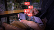 © kingkai - Smartphone with Floating Social Media Metrics in Cafe Environment