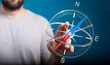 © vegefox.com - A close-up of a person holding a digital compass, symbolizing guidance, direction, and navigation, with copy space and a blue background.
