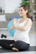 © auremar - pregnant woman on a yoga mat