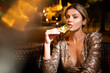© Volodymyr - Elegant woman eating pizza in night cafe. Sensual woman enjoying food in luxury setting. Woman posing with gourmet pizza slice. Urban nightlife.