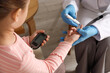 © New Africa - Diabetes. Doctor in medical gloves checking little girl's blood sugar level with lancet pen and glucometer indoors, closeup