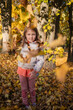 © Vladyslav - A beautiful little Caucasian girl poses in autumn clothing against an autumn backdrop on a sunny autumn day. The girl wears a crown of yellow maple leaves, holding an autumn bouquet of fallen leaves