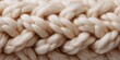 © Andrii Zastrozhnov - Close-up of thick beige yarn knitting texture with braided pattern