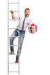 © Ljupco Smokovski - Man climbing a ladder and holding a present