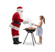 © Ljupco Smokovski - Santa claus cooking bbq and giving meat to a girl