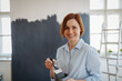 © Halfpoint - Beautiful woman painting walls of her new apartment by herself.
